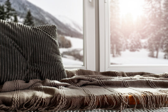 A window with an empty sill and a winter landscape in the background on a beautiful sunny day 