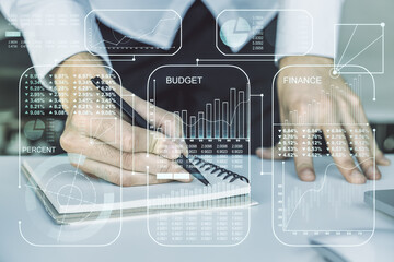 Multi exposure of creative statistics data hologram with hand writing in notebook on background with laptop, stats and analytics concept