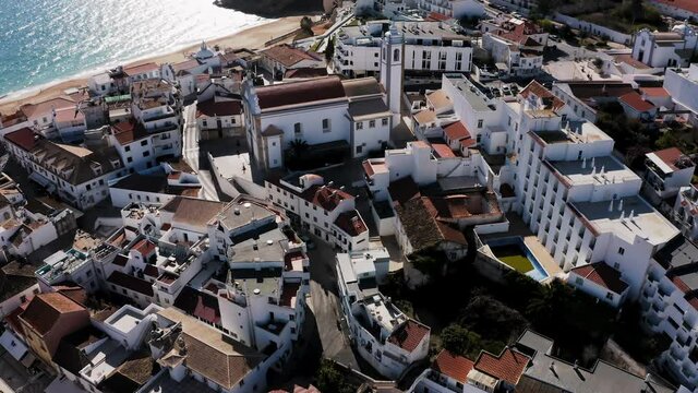 Albufeira cinematic drone aerial view. Drone flight over beautiful coastline, beach and old town. Sunny weather at the Atlantic ocean.  