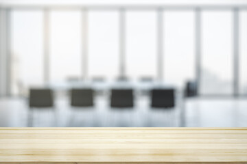 Empty office wooden table with empty space on modern conference room with large window background, closeup, mockup