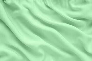 Green silk texture, abstract background luxury fabric with wavy folds