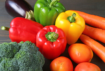 Colorful assorted fresh vegetables on black wooden background or the concept of WELLNESS