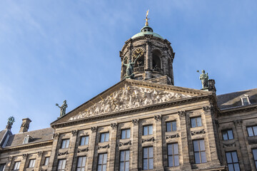 Architectural fragments of Amsterdam Royal Palace building (Koninklijk Paleis) at Dam Square. Classicism style Palace built as city hall during Dutch Golden Age (1648 - 1655). Amsterdam, Netherlands.