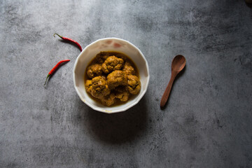 Gobi masala curry or cauliflower roast served in a white bowl. Top view.
