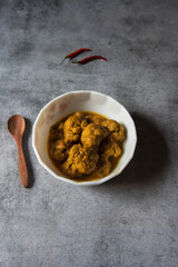 Gobi masala curry or cauliflower roast served in a white bowl. Top view.