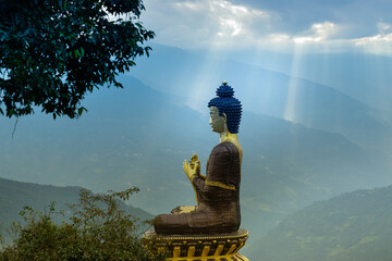 Sunrays falling on Beautiful huge statue of Lord Buddha, at Rabangla , Sikkim , India. Surrounded...