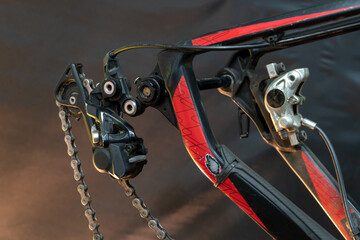 mountain bike in the workshop. Bicycle rear derailleur close-up on a black background. The concept...