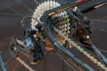 mountain bike in the workshop. Bicycle rear derailleur close-up on a black background. The concept of cycling improves health and mood.
