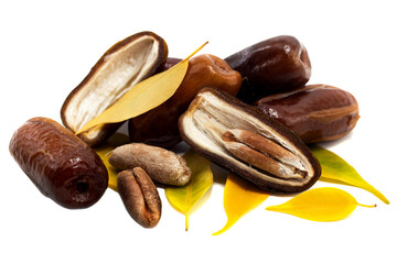 Dates on a white background. Dates isolate with seeds and leaves.