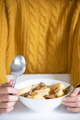 Vertical front view of person with potato stew