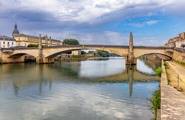 Chalon-sur-Saone, France, beautiful stone arch bridge over the Saone river in Saint-Remy, in cloudy day