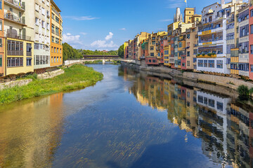 Spain, Catalonia, Colorful houses in Girona on the river bank, with a slight reflection in the water