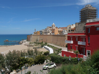 Panorama of the Swabian Castle of Termoli enclosed by the city walls with towers overlooking the Adriatic Sea and on the ancient fishing machine called Trabucco.
