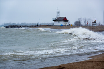 Winter waves arrive on the shore of Lake Ontario in Toronto&rsquo;s iconic Beaches neighbourhood as a small snow storm begins. Shot in in late December