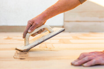 Tiler installing tile on terrace floor. Home outdors renovation.