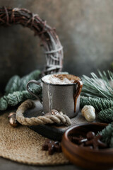 Hot cocoa drink with fluffy milk froth in a vintage mug. Warm Christmas drinks with chocolates