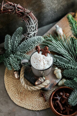 Hot cocoa drink with fluffy milk froth in a vintage mug. Warm Christmas drinks with chocolates