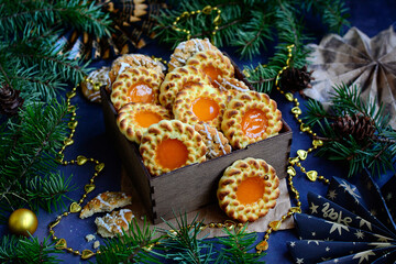 Fototapeta na wymiar Christmas cookies with festive decor on the background of fir branches. New Year's gift concept