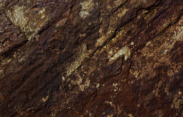 Old rusty granite rock with lots of cracks, grungy background.