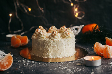 Christmas cake. Delicious cake with winter decor. Cake with tangerines on the table 