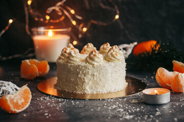Christmas cake. Delicious cake with winter decor. Cake with tangerines on the table 