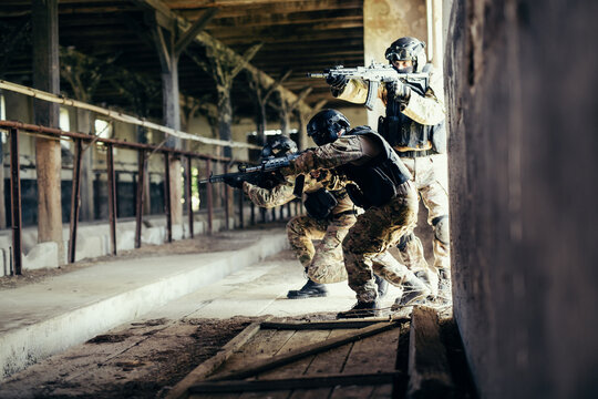 Airsoft soldier with a rifle playing strike-ball.