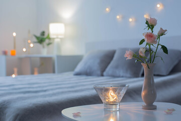 pink roses in vase on table in bedroom