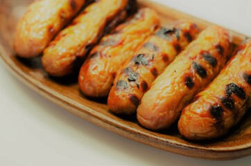 Grilled classic British sausage made from prime cuts of pork on the wooden plate