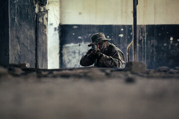 Airsoft solder on battlefield. Airsoft soldier with a rifle.