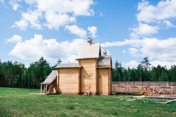 An old wooden Orthodox church in a Russian village on a summer day