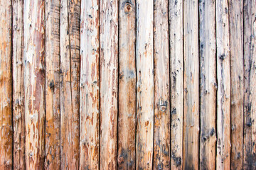 Aged background wooden gnarled natural fence made of vertical planks