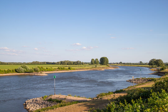 The Dutch river IJssel flows peacefully through the typical Dutch landscape.