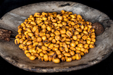 Many corn nuts in the old rustic wooden bowl