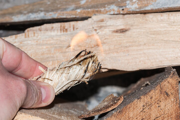 close-up of a hand lighting a fire