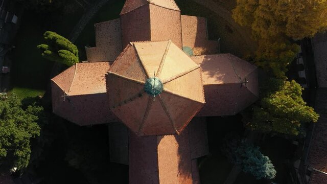 Drone going up from top of medieval fortified church in Transylvania, Romania. Prejmer fortified church seen from above with details on the roof and cross, camera going up