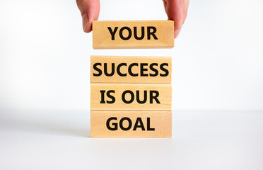 Your success is our goal symbol. Concept words Your success is our goal. Businessman hand. Beautiful white table, white background, copy space. Success business goal concept.