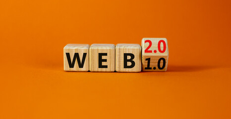 WEB 1.0 or 2.0 symbol. Turned a wooden cube and changed words WEB 1.0 to WEB 2.0. Beautiful orange table, orange background, copy space. Business, technology and WEB 1.0 or 2.0 concept.