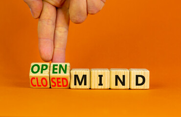 Open or closed mind symbol. Businessman turns cubes and changes concept words closrd mind to open...