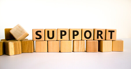 Support symbol. The concept word Support on wooden cubes. Beautiful white table, white background, copy space. Business and support concept.
