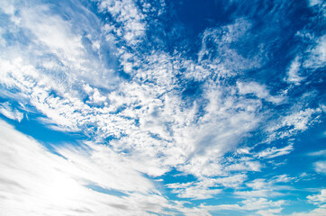 Naklejka na ściany i meble blue sky with white clouds and sun on a wide-angle lens