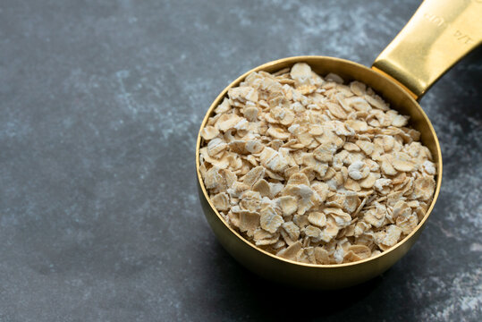 Rolled Oats in a Gold Measuring Cup
