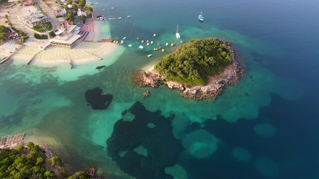 flying around scenic Albanian beach with turquoise water, aerial view of Ksamil, seascape of Balkans coast, vacations travel concept