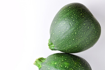 Zenith view, round zucchini on light background. Copy space.
