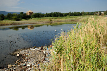 The lake and the shore are littered with garbage
