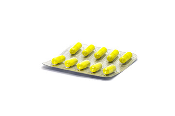 Pack of yellow pills on a white background