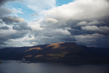 Naklejka premium Putorana plateau Lake Lama at day time, mountains and clouds on the background