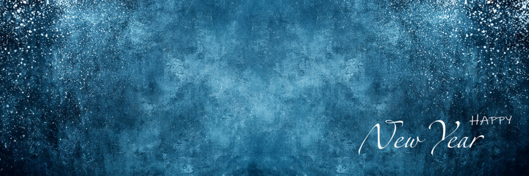 Blue Christmas background with New Year greetings inscription and snow splashes on it.