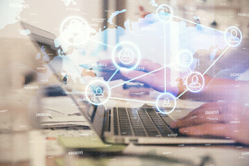 Double exposure of woman hands typing on computer and social network theme hologram drawing. People media concept.