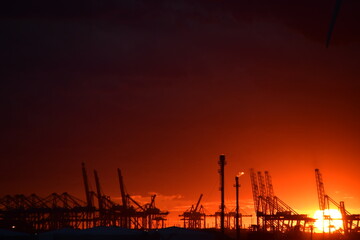 Flaming red sunset over an Oil Refinery in the Netherlands
