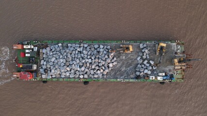 Overhead view of barge delivering rock to Withernsea, UK
